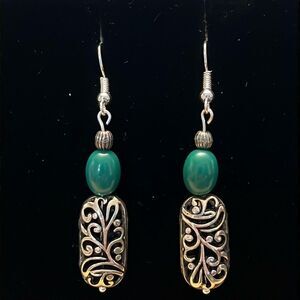 Handcrafted silver tone earrings with green beading.